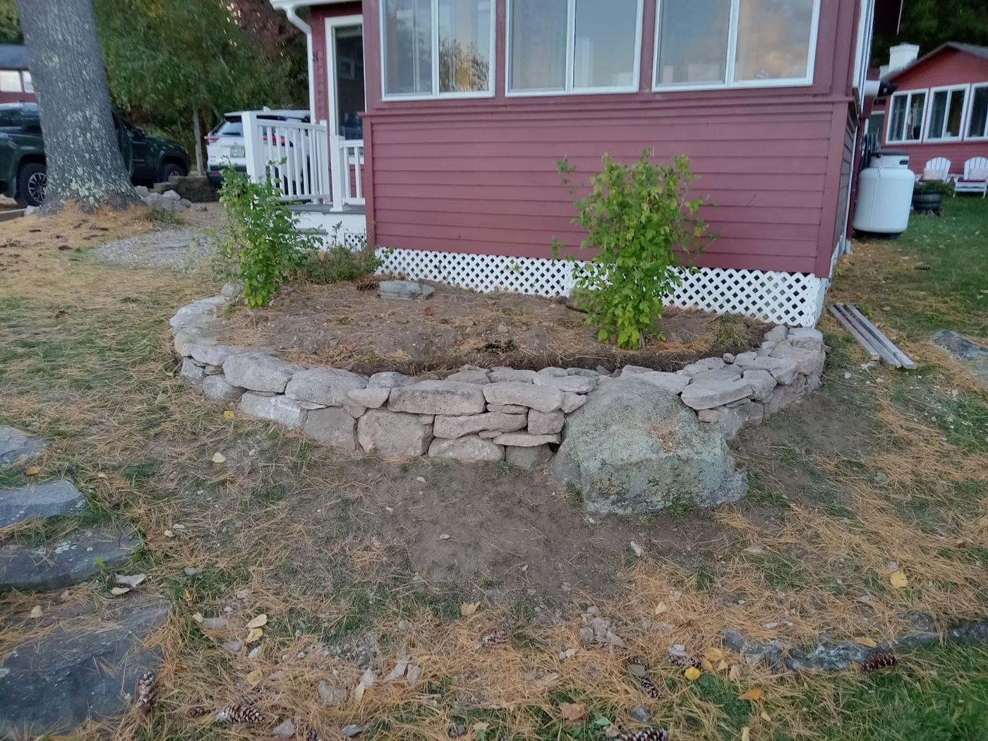 Stone ring around a garden bed