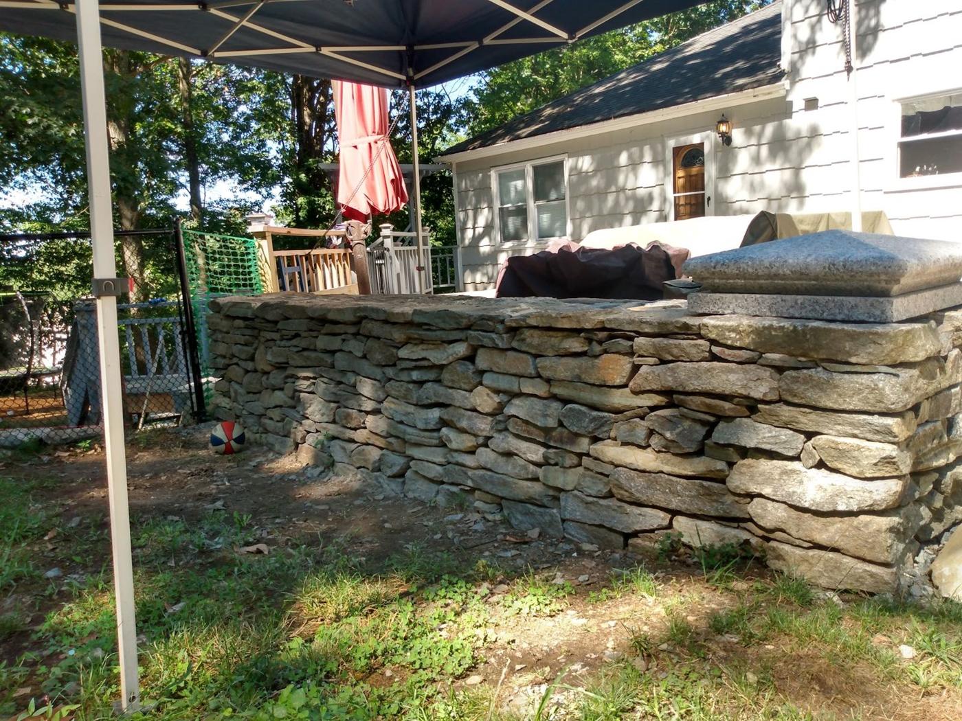 Dry stacked stone wall with a capstone