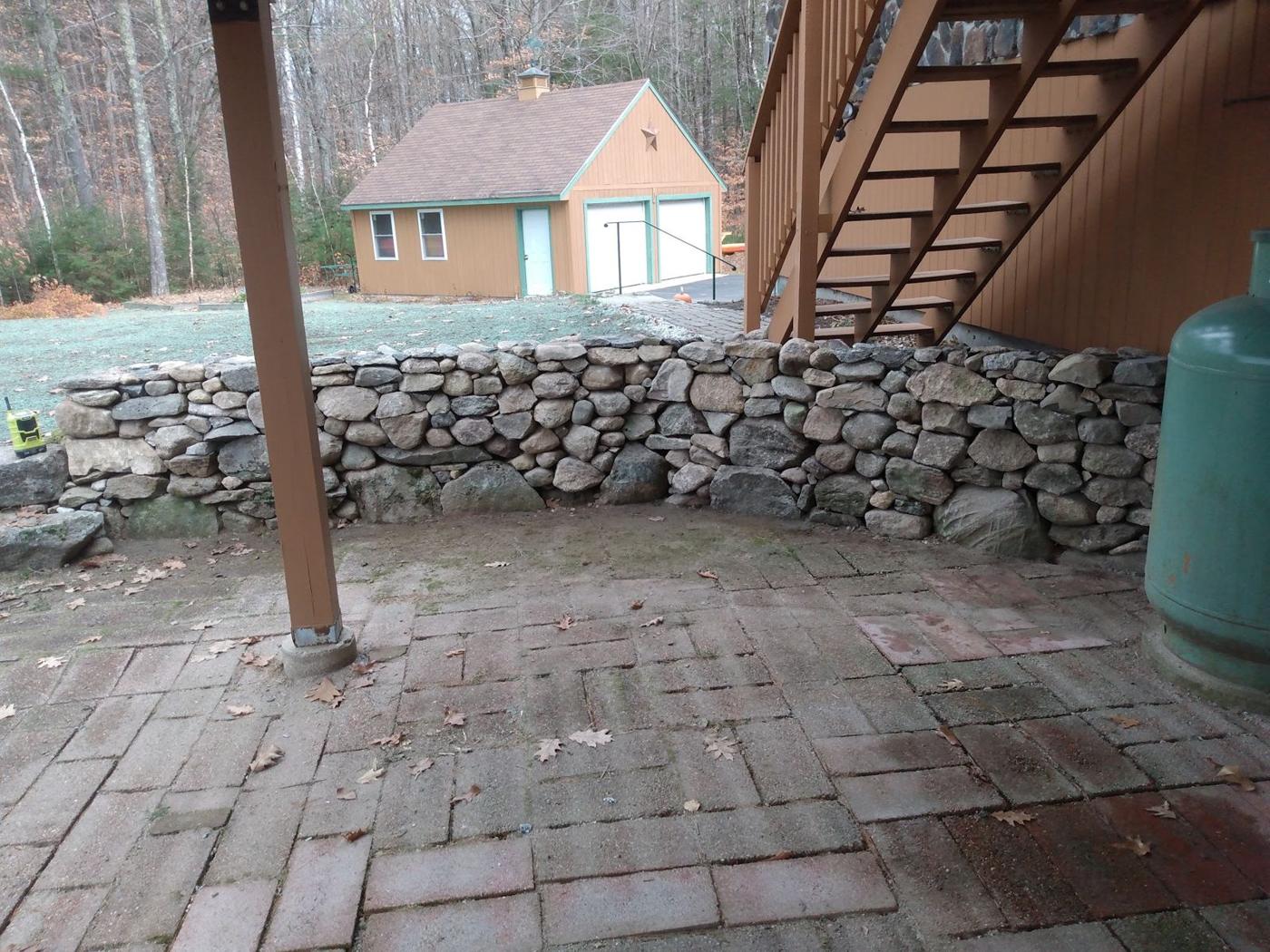 Fieldstone wall under a deck